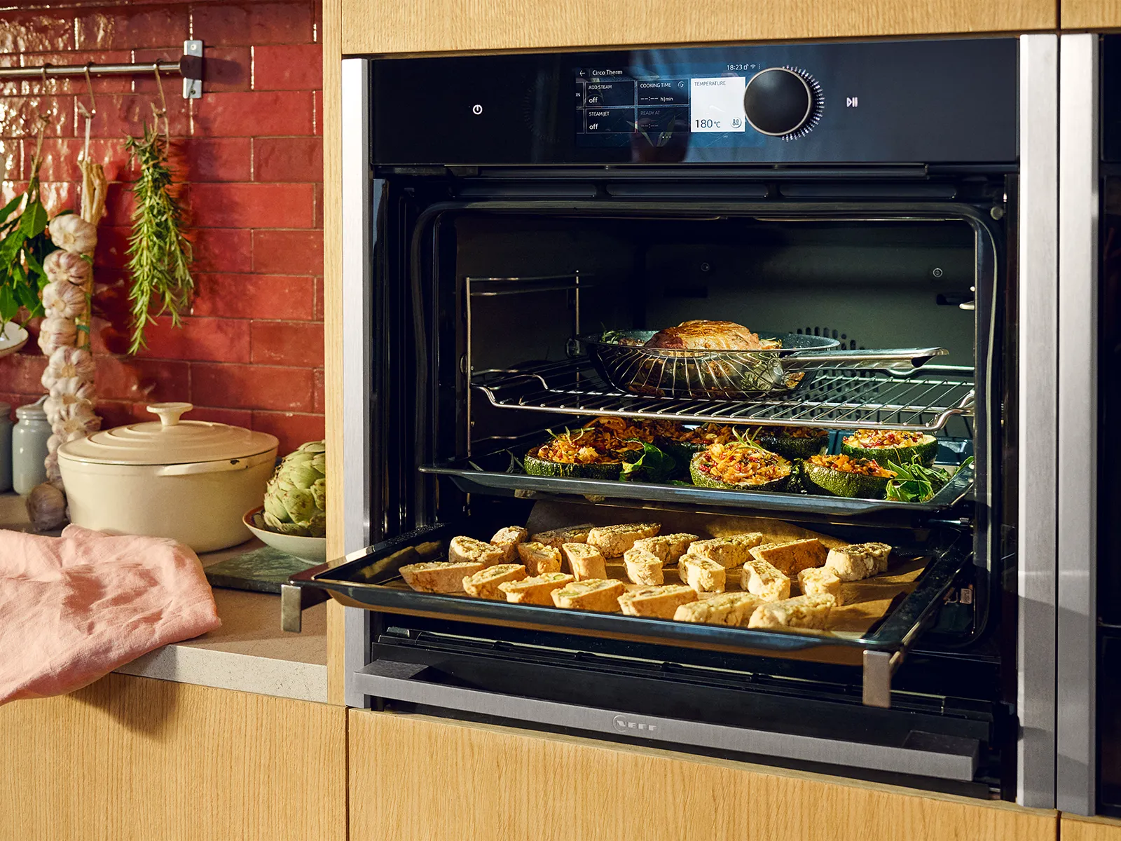 Slide & Hide feature on N90 oven with open door, with food baking on 3 levels  