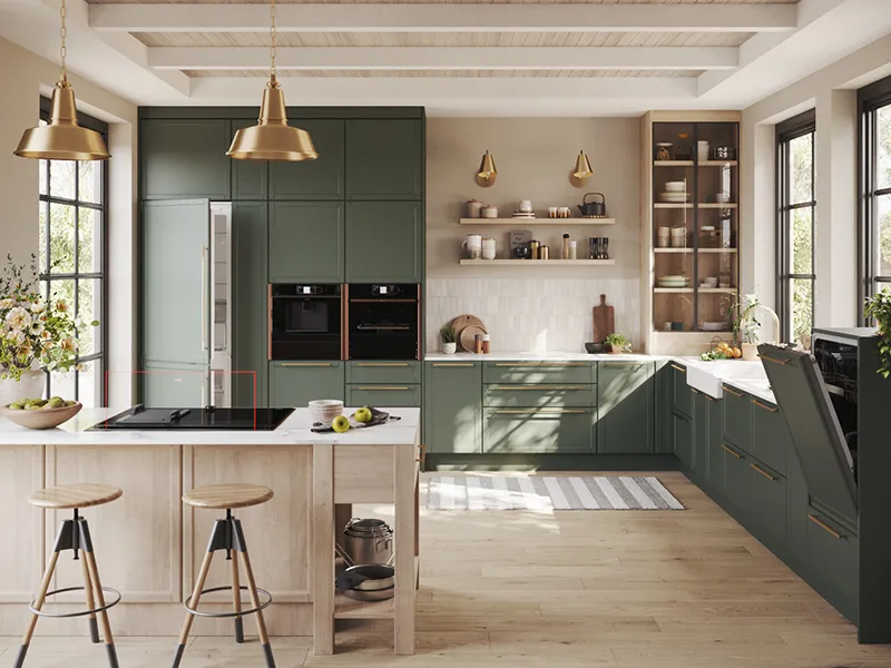 A spacious and modern kitchen with dark green cabinets, a large central island with a cooktop, and fully integrated appliances, including a refrigerator and ovens.