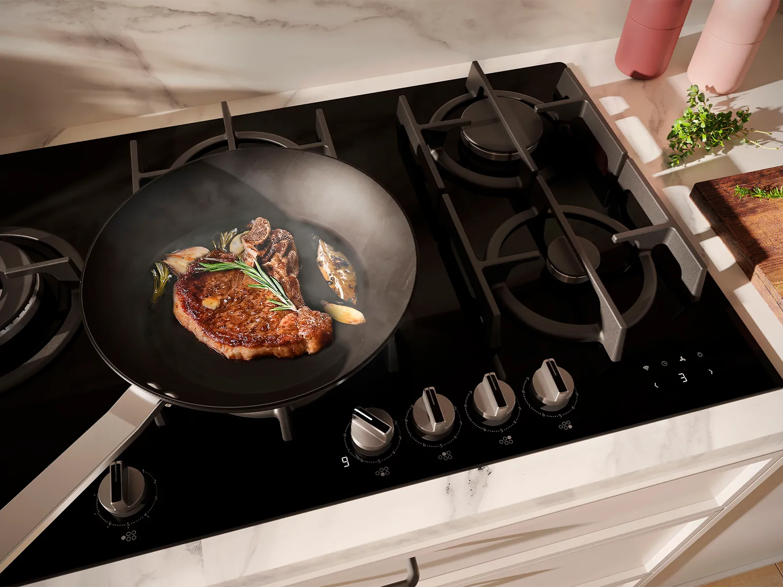 A sizzling steak with garlic and rosemary cooks in a frying pan on a modern gas hob.