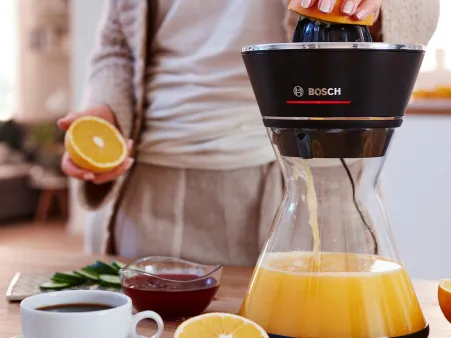 The Bosch citrus press VitaStyle standing on a kitchen worktop.