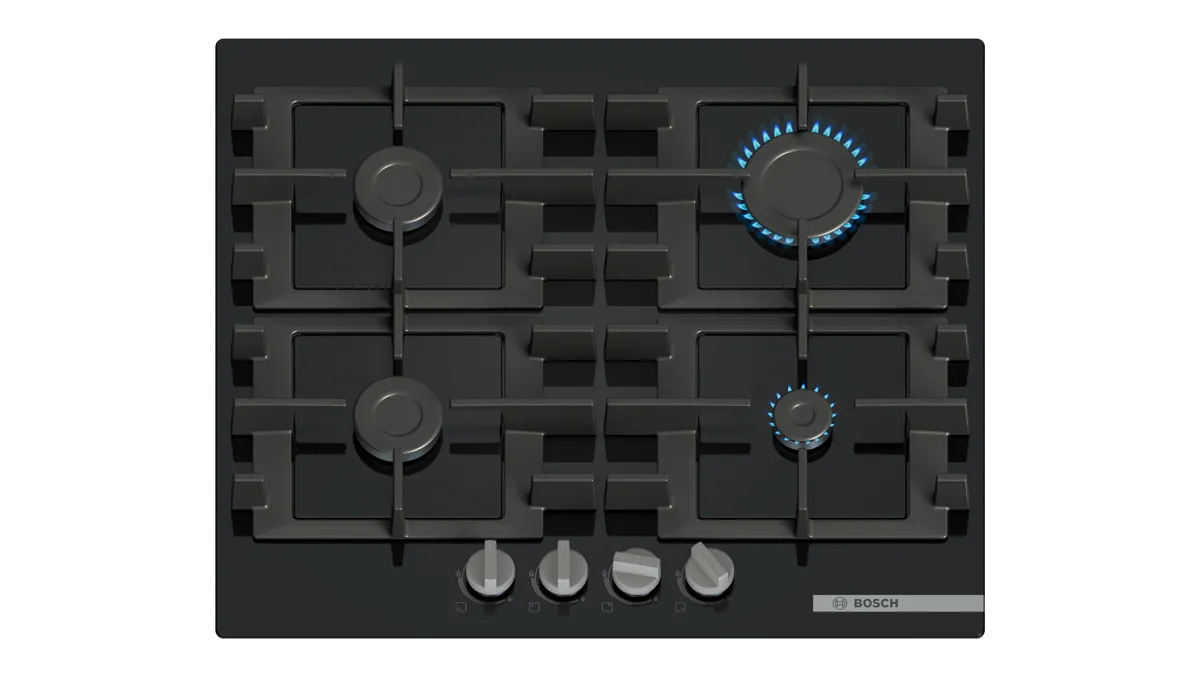 Black gas cooktop with four burners and control knobs, featuring one burner illuminated by a blue flame.