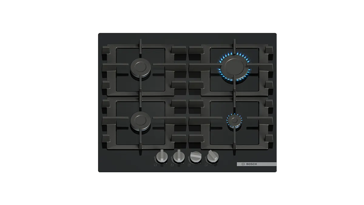 Black gas stovetop with five burners, including one larger burner with blue flame, and silver control knobs at the bottom.