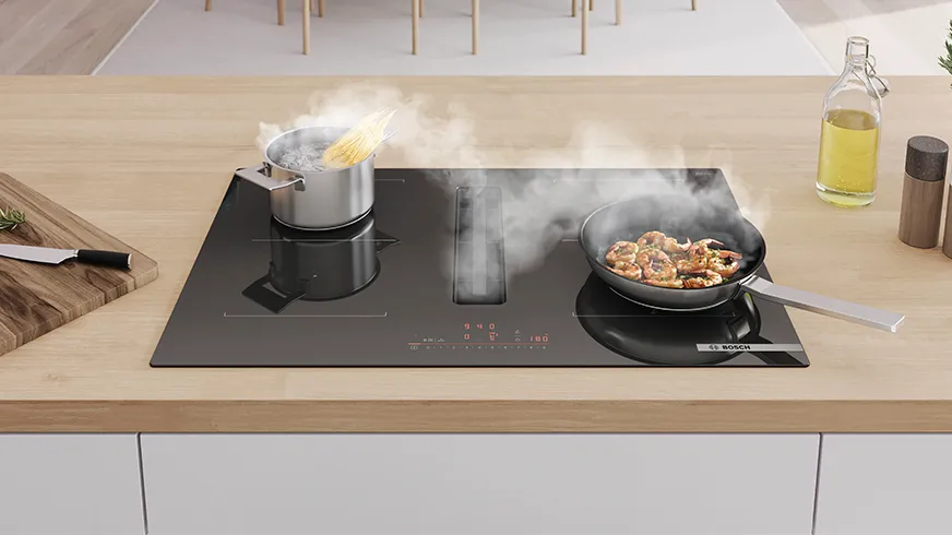 Venting hob on kitchen counter extracting steam