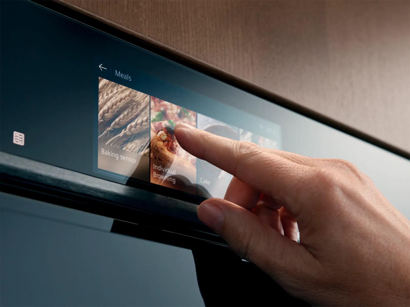 A hand interacting with a sleek touchscreen display on a modern oven, selecting Individual Browning option for cooking.