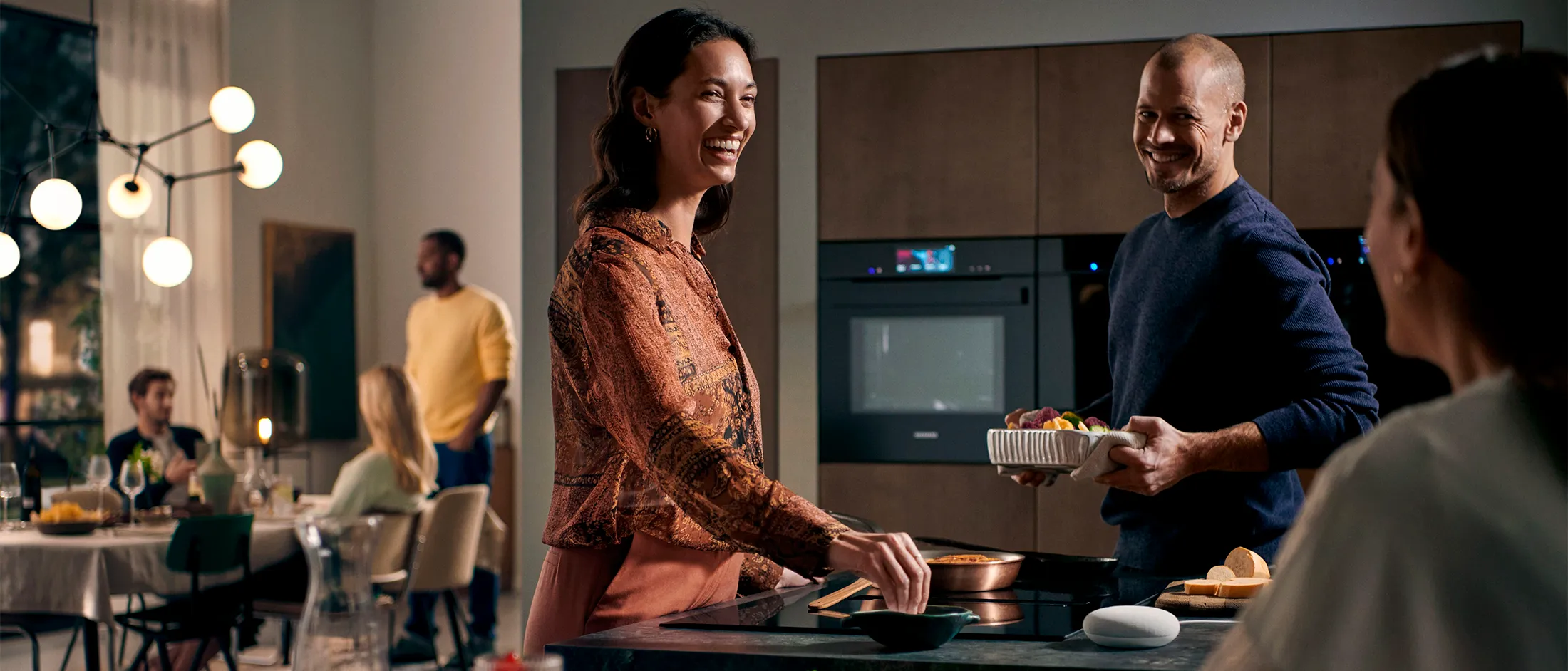 Kitchen scene with people and Siemens oven in the background