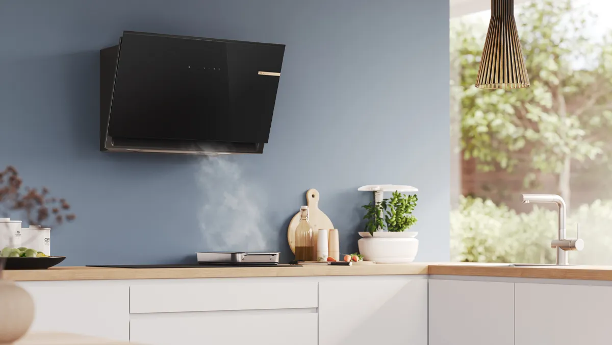 Wall mounted hood extracting steam from pan