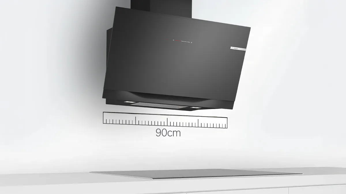 A black kitchen hood mounted above a cooktop, with a 90cm measuring scale displayed for reference.