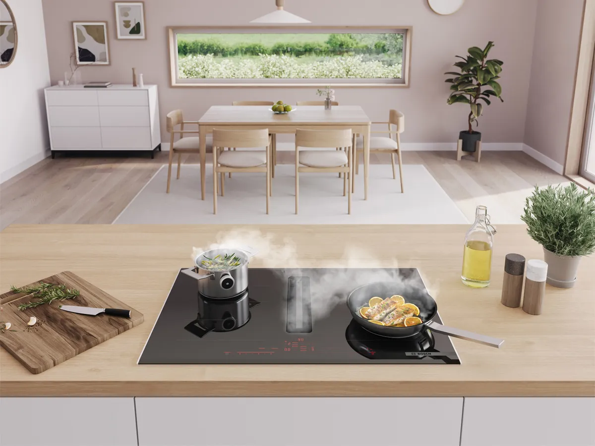 Pans cooking on vented hob whilst it extracts steam