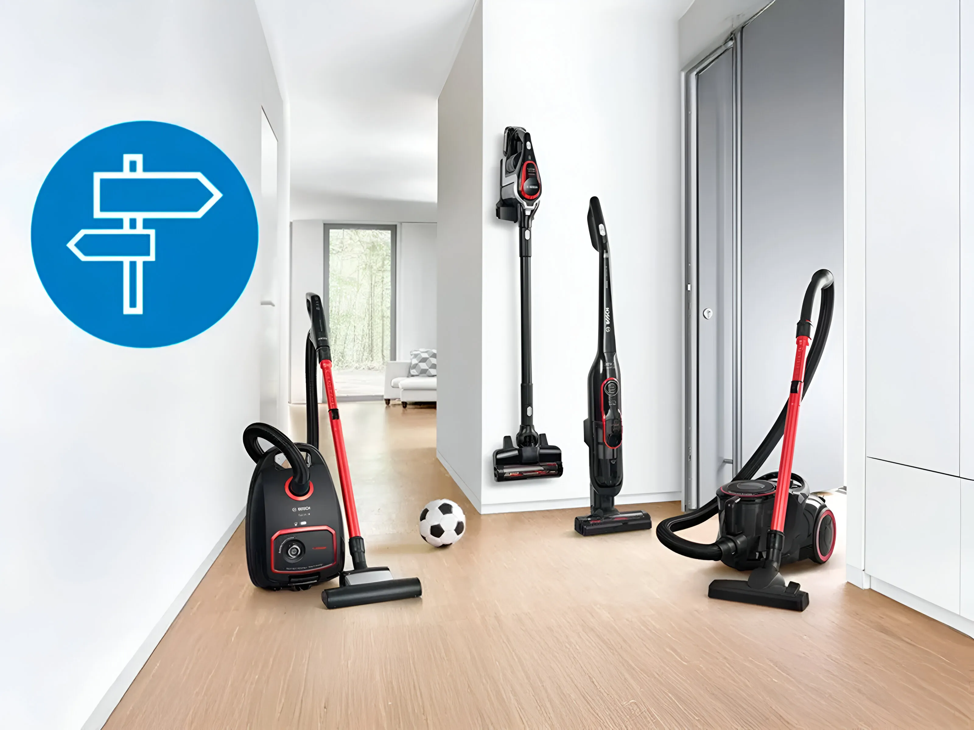 A modern hallway featuring various vacuum cleaners alongside a soccer ball on the floor.