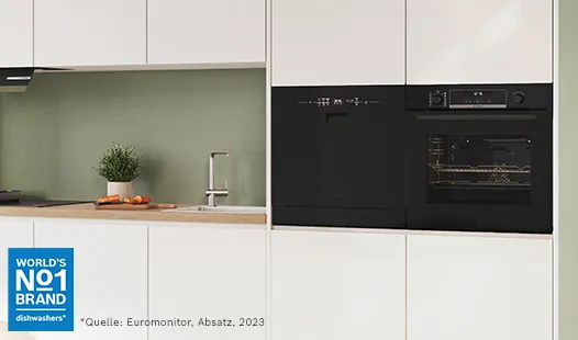 Eine moderne Küche mit einem eleganten schwarzen Geschirrspüler und Backofen, mit minimalistischem Design und einer grünen Akzentwand.