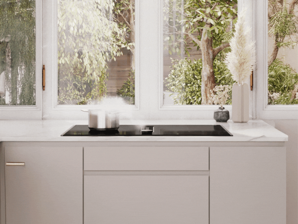 View of a bright modern kitchen with a hob with integrated ventilation under the window