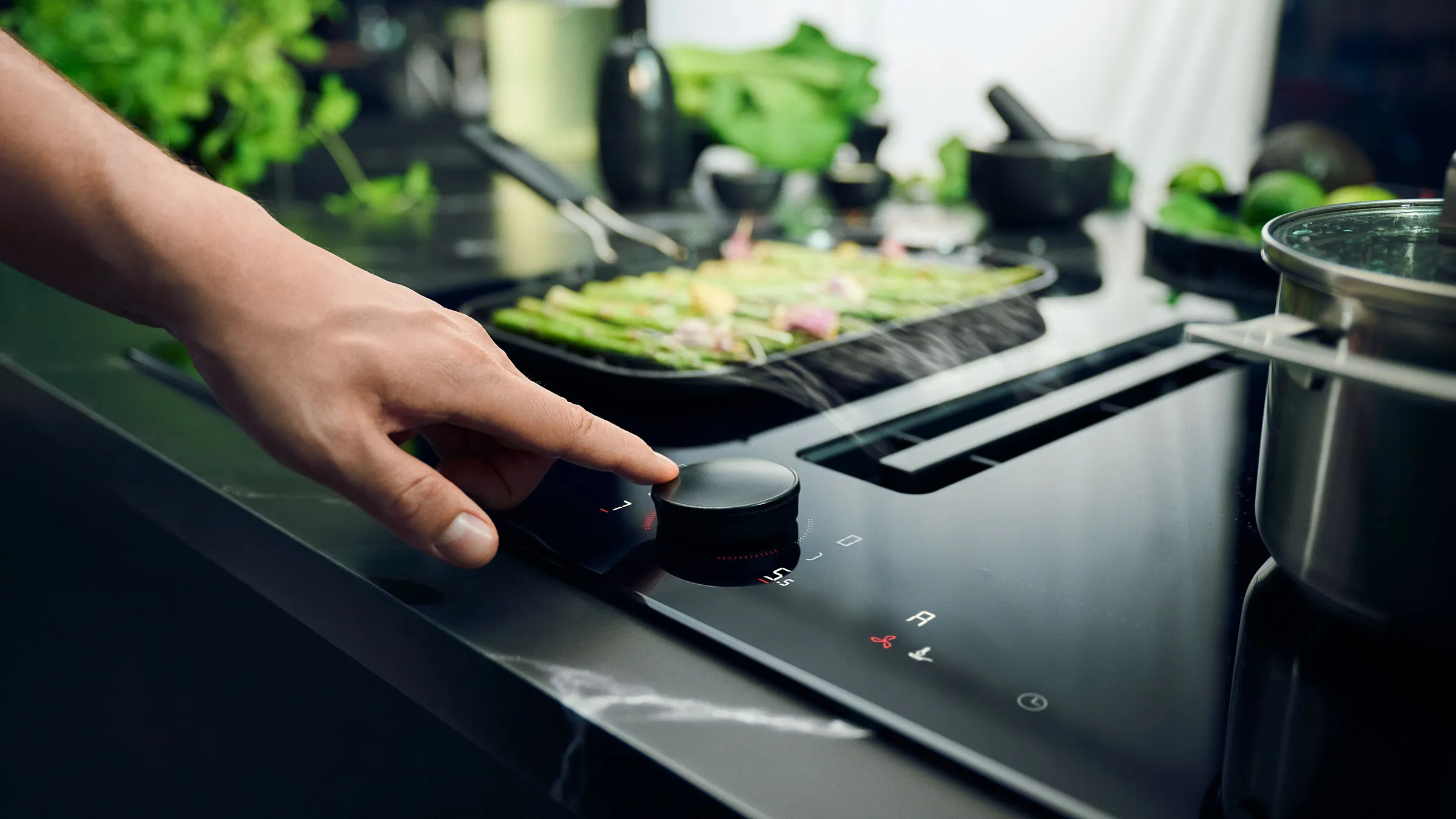Person using controls on Neff hob