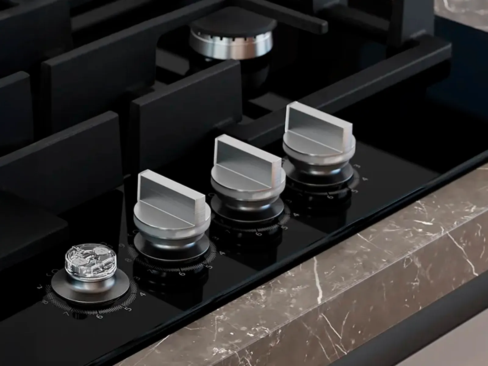 A close-up shot of the gas hob knobs with one knob removed.