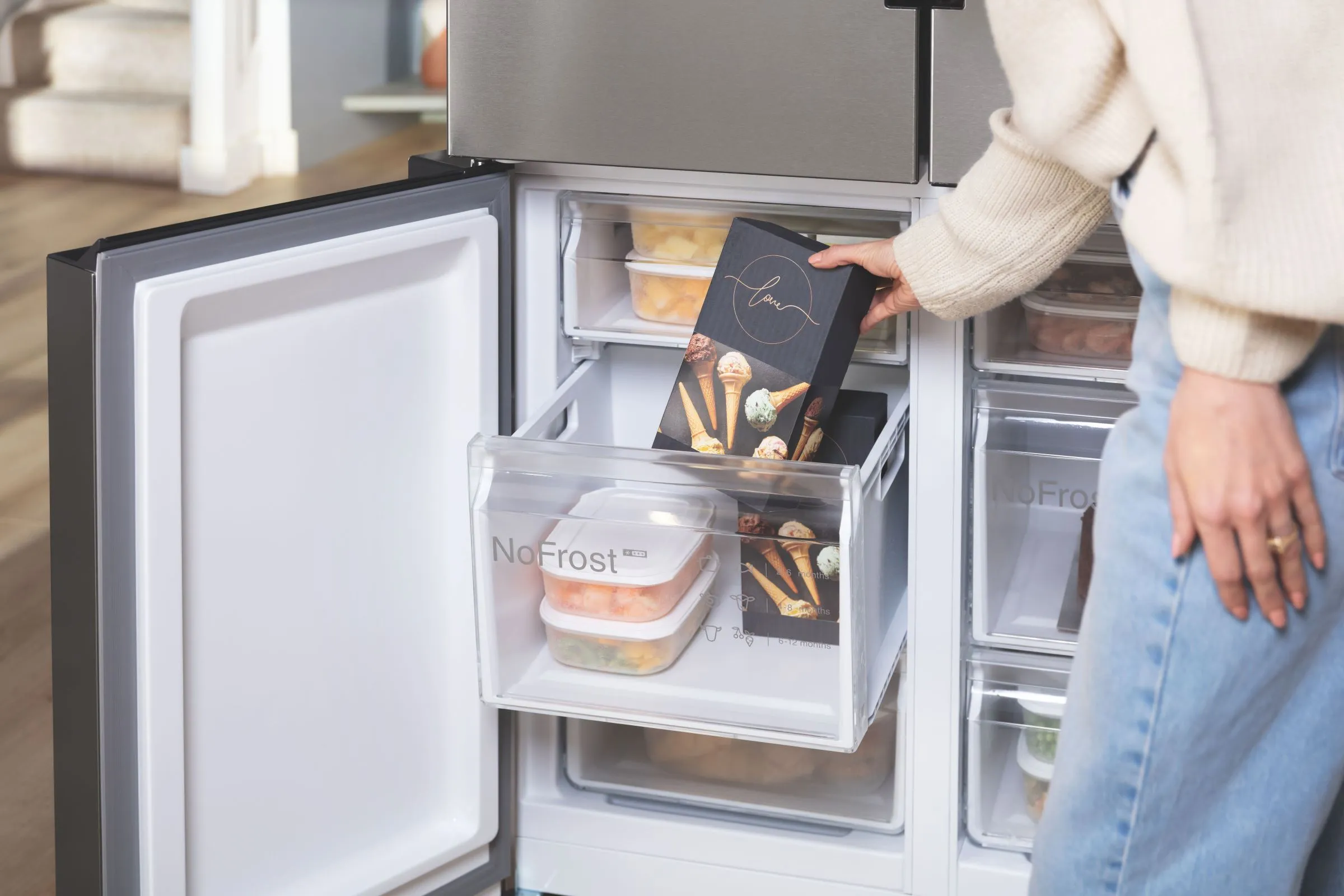 Person putting box in freezer with no frost feature