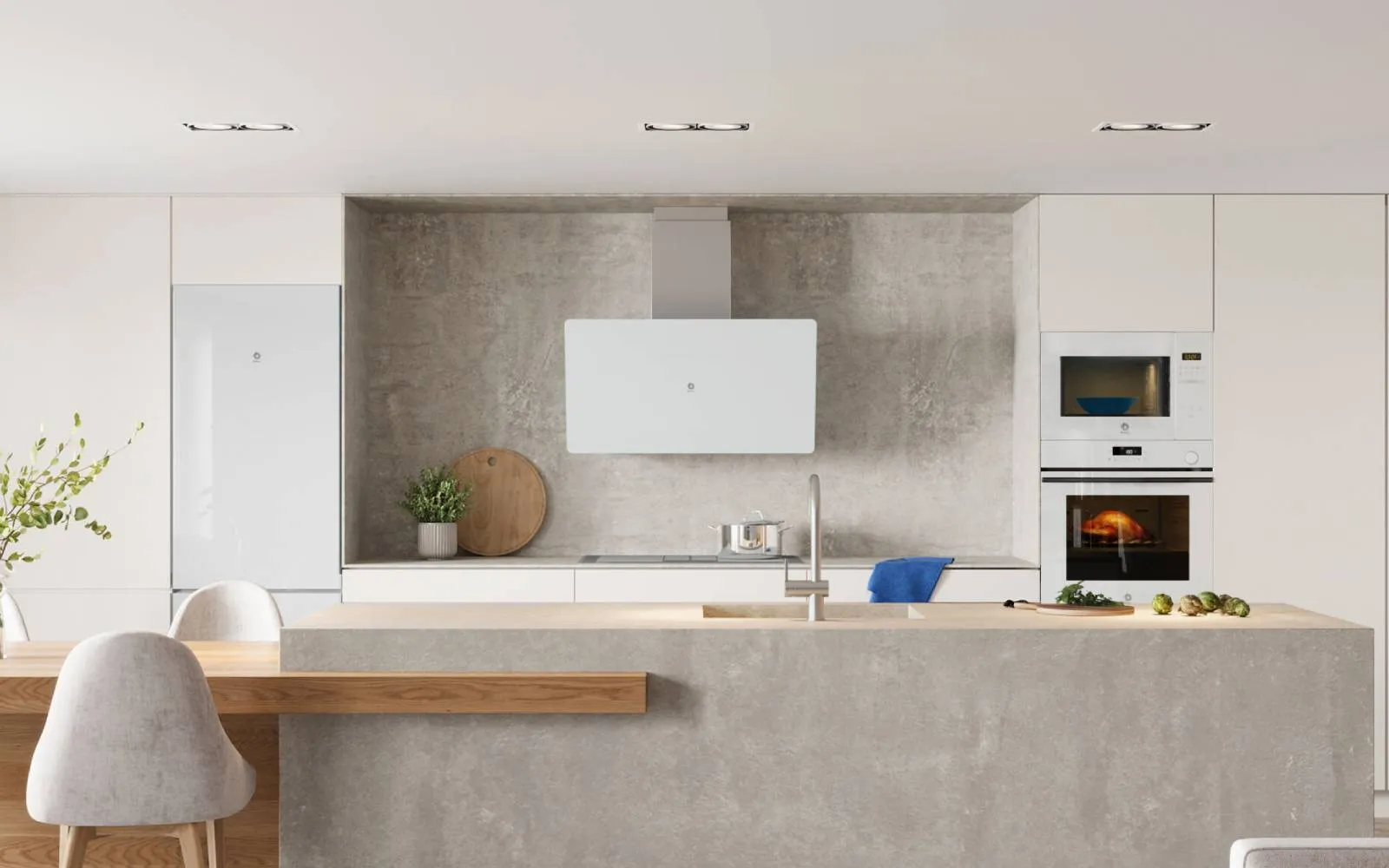 Cocina moderna con isla de hormigón, armarios blancos, horno y microondas integrados Balay.