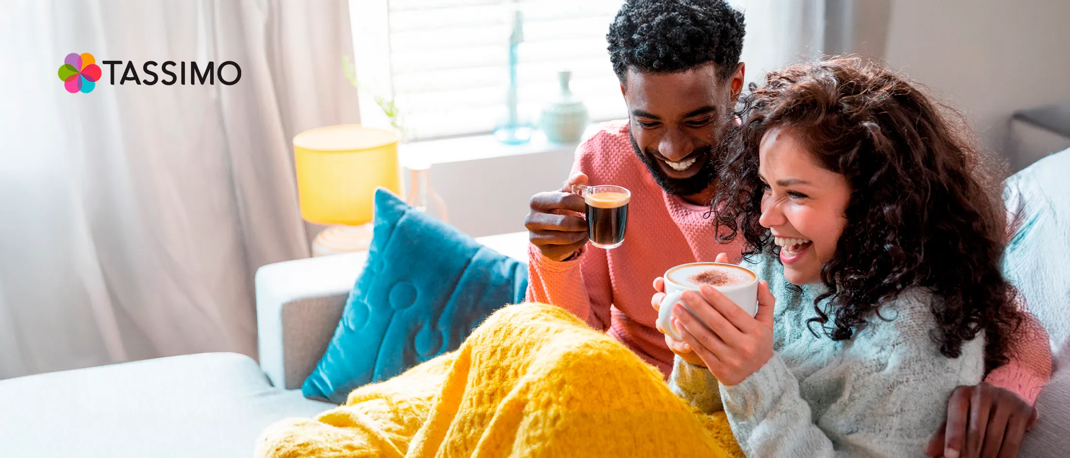 Couple drinking coffee together in bed.
