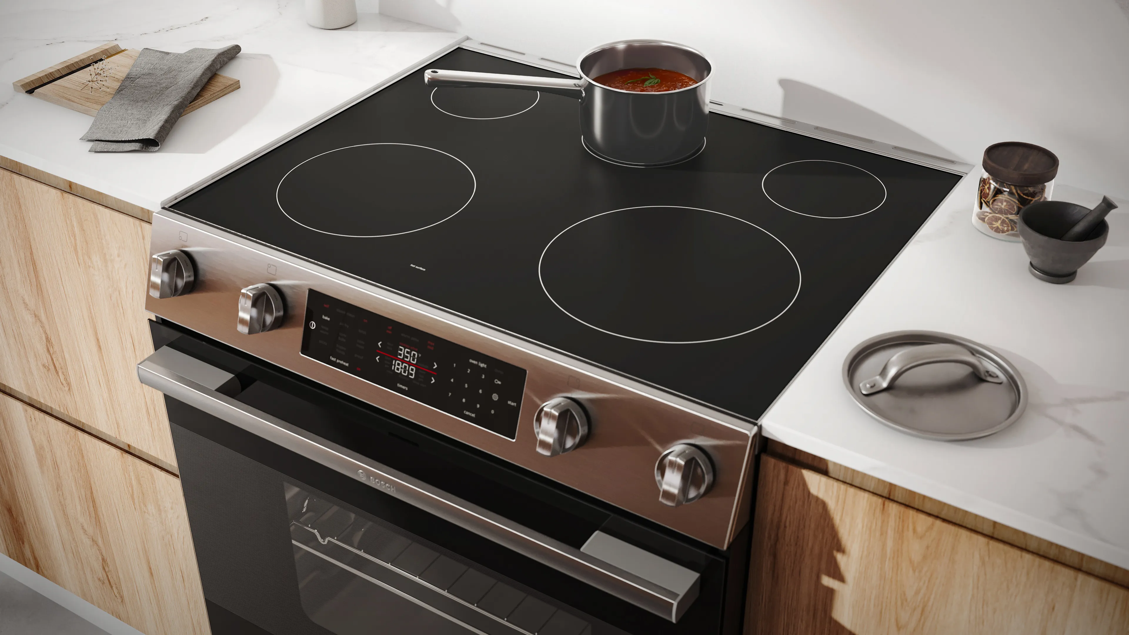 Bosch 100 series electric range with small sauce pan on the middle back burner