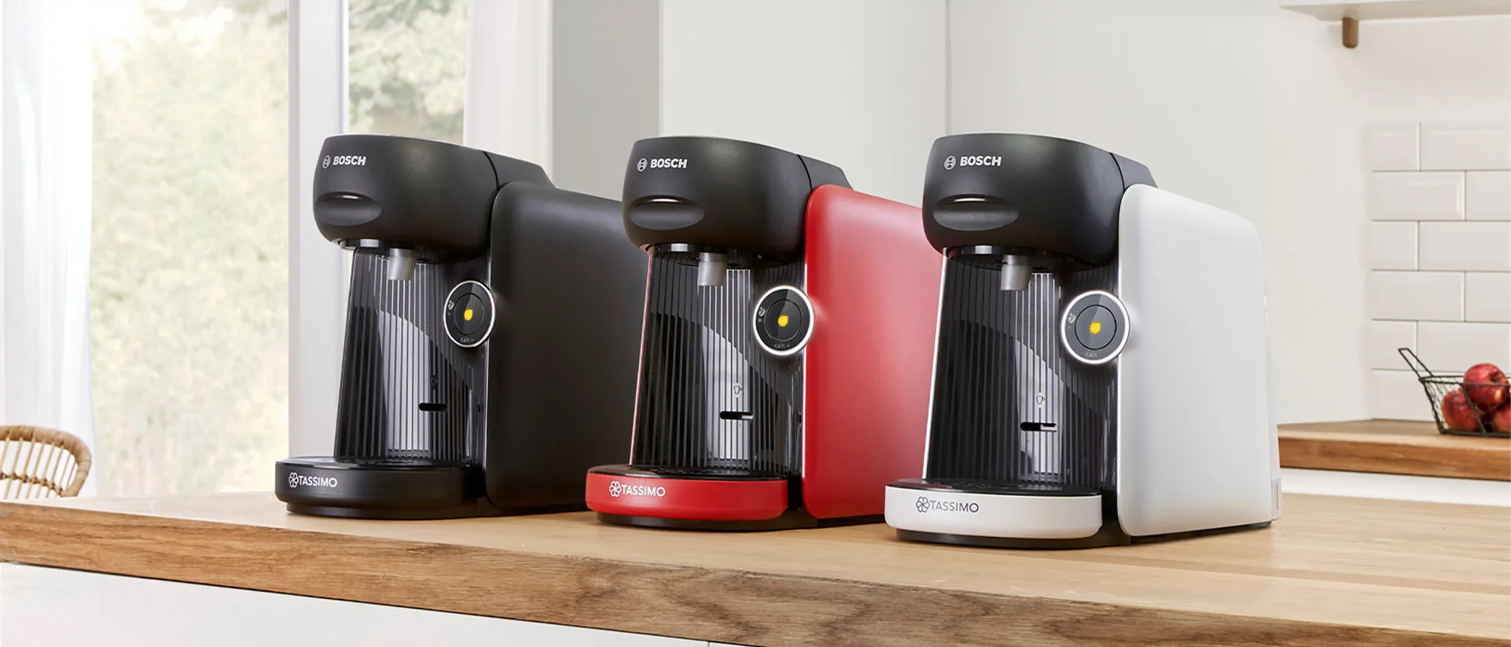 Different colours of the TASSIMO FINESSE friendly coffee machine on a kitchen worktop.
