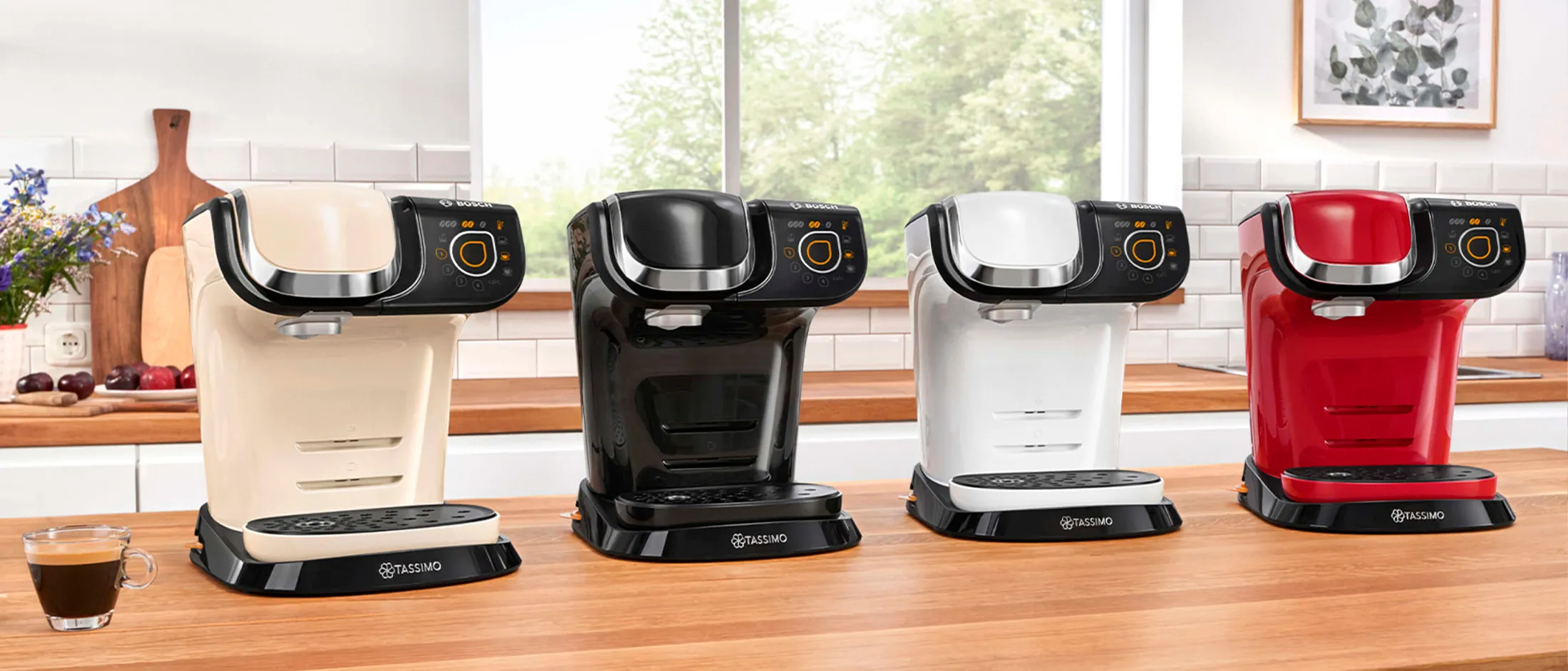 The TASSIMO coffee machines MYWAY 2 in four different colours standing on a kitchen worktop.