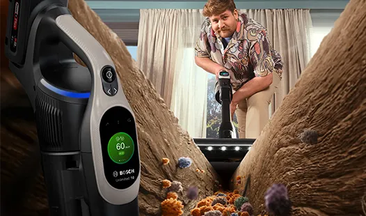 Un aspirapolvere Bosch è esposto in bella vista, mentre una persona pulisce un tappeto pieno di sporco e allergeni.