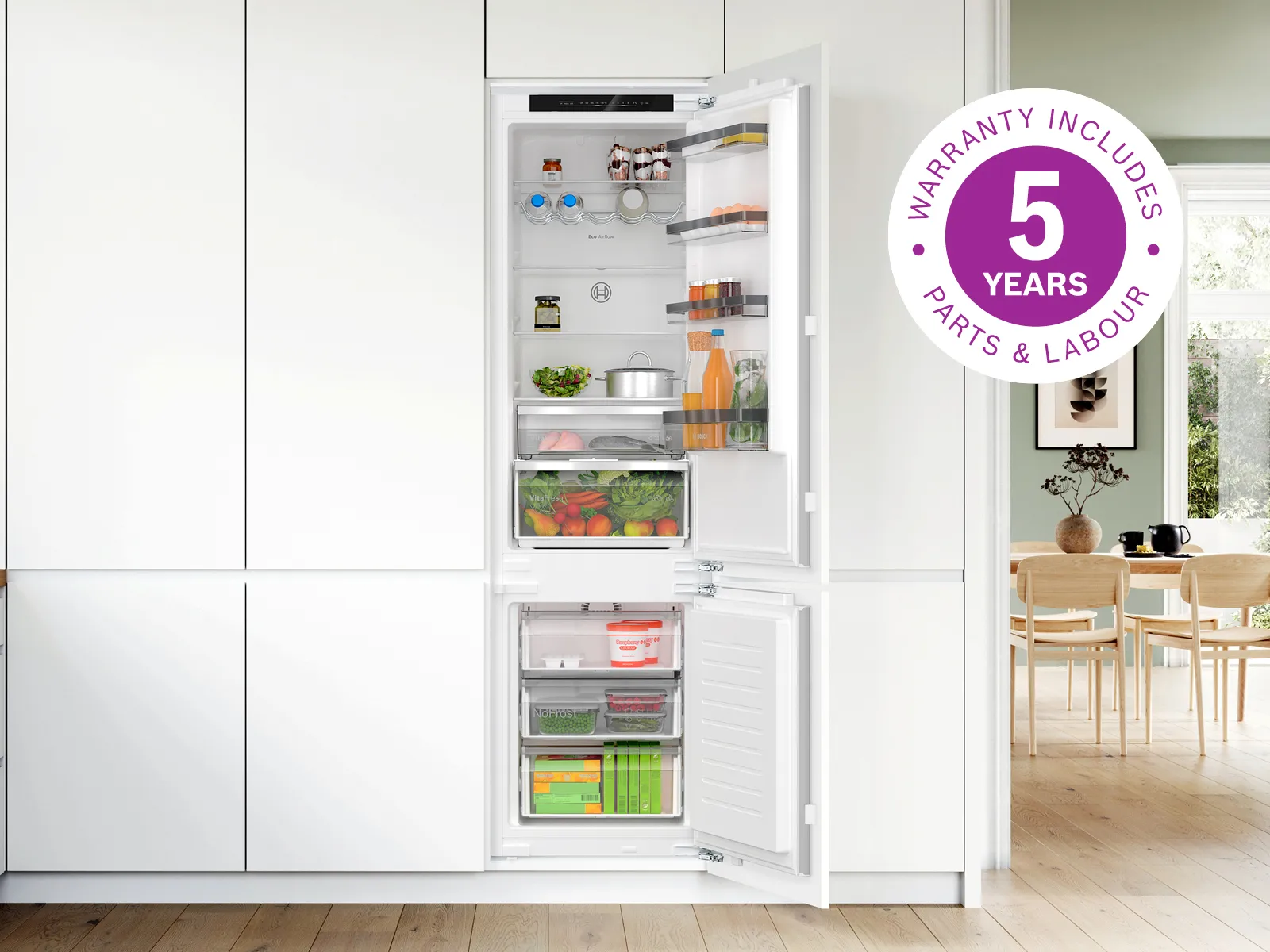 Open fridge freezer with 5 year warranty badge overlay