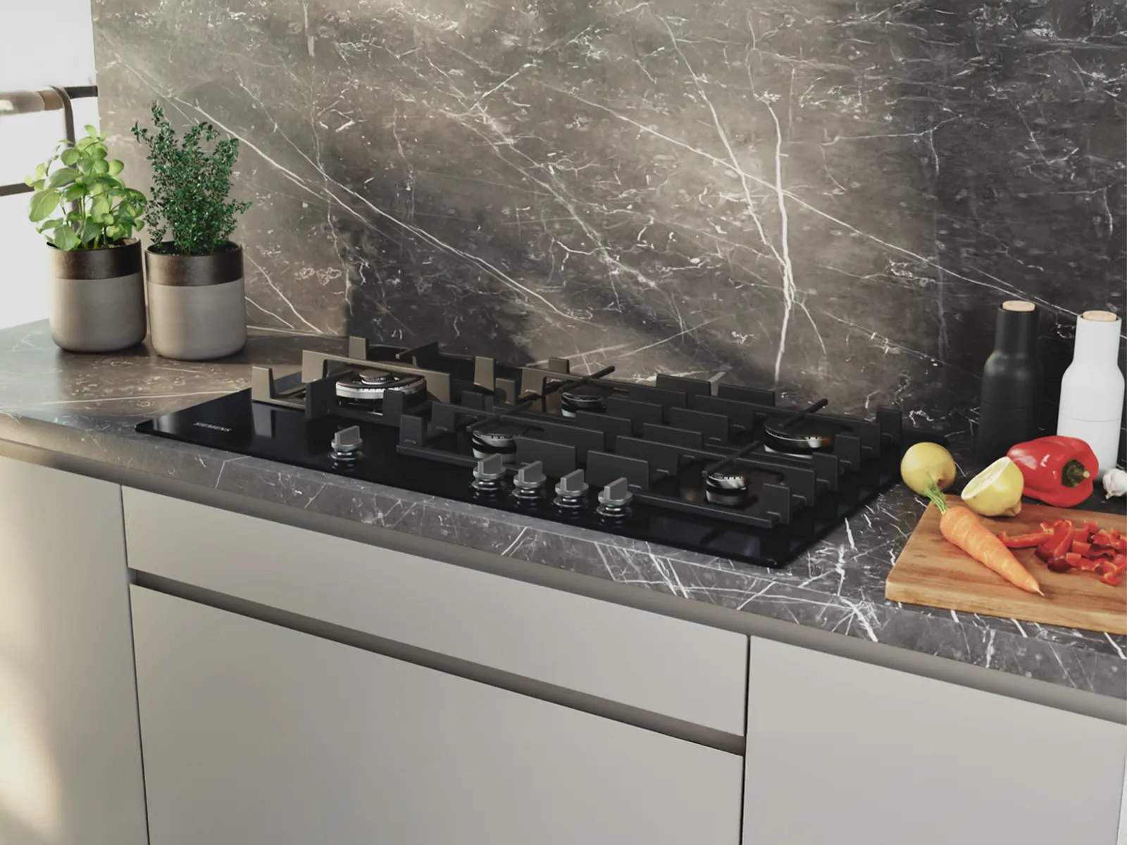 A sleek black gas cooktop on a marble countertop with herbs, spices, and chopped vegetables, set in a modern kitchen.