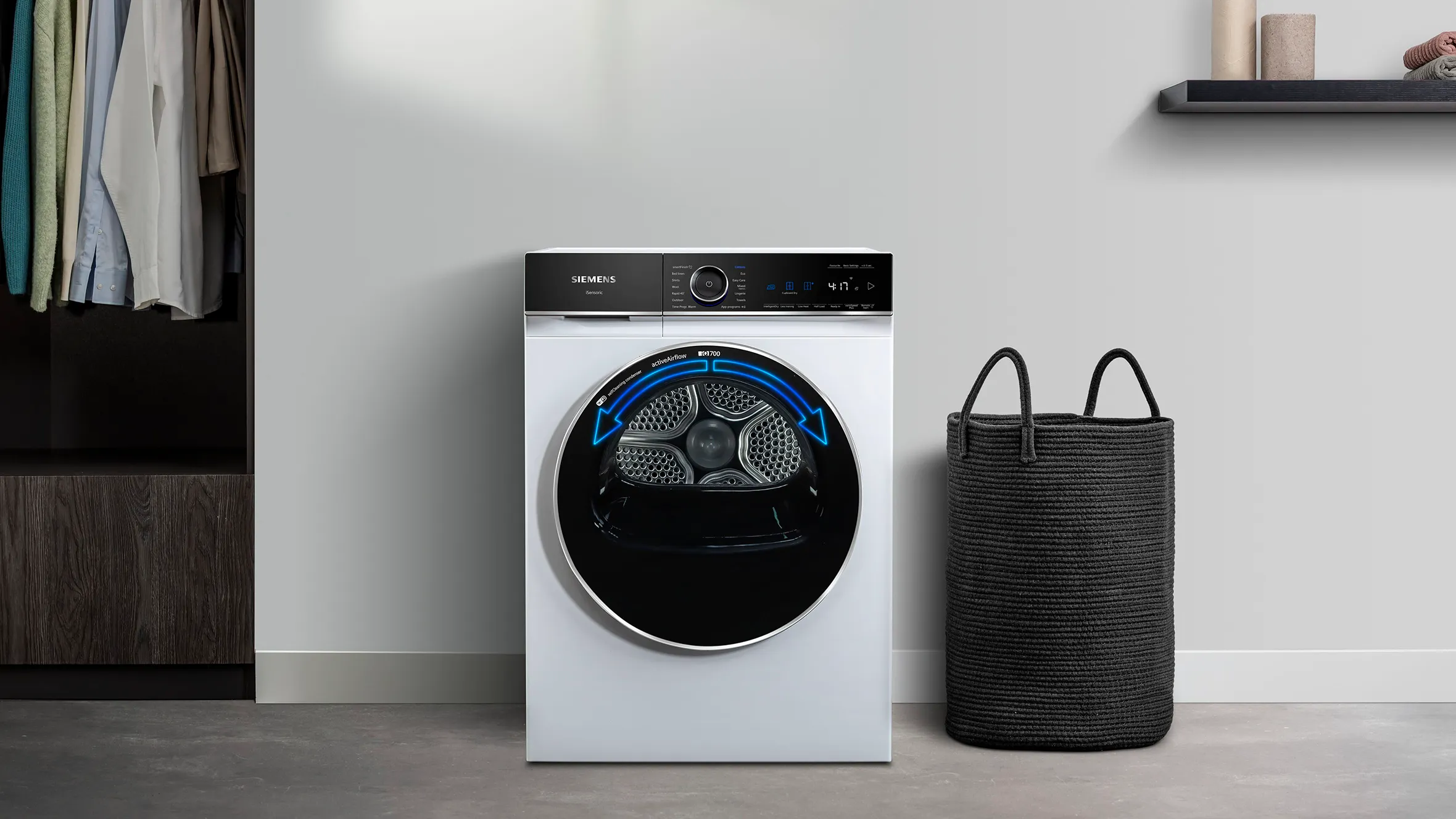 Dryer against a wall with a laundry basket