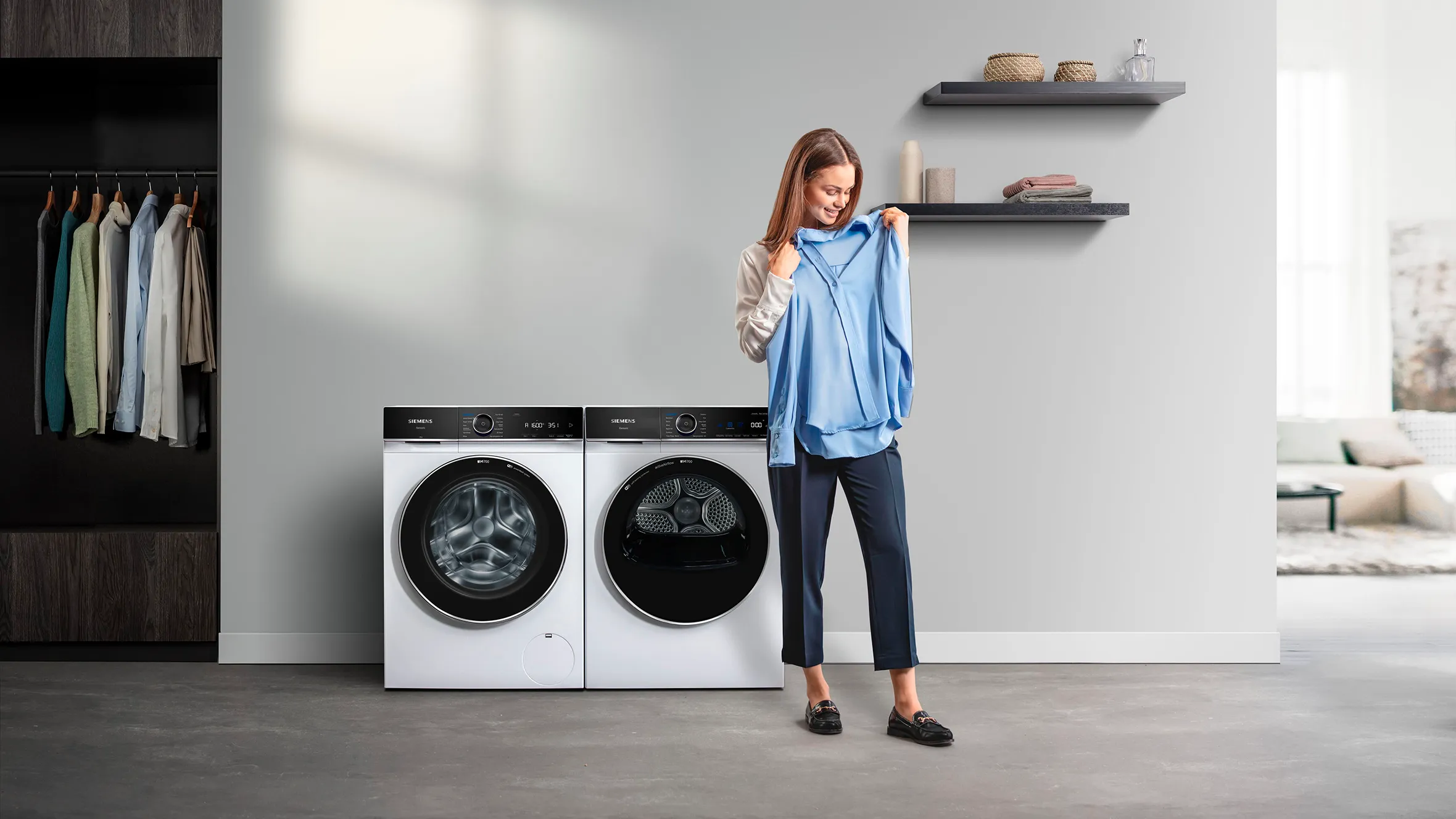 woman holding a clean shirt in amodern house