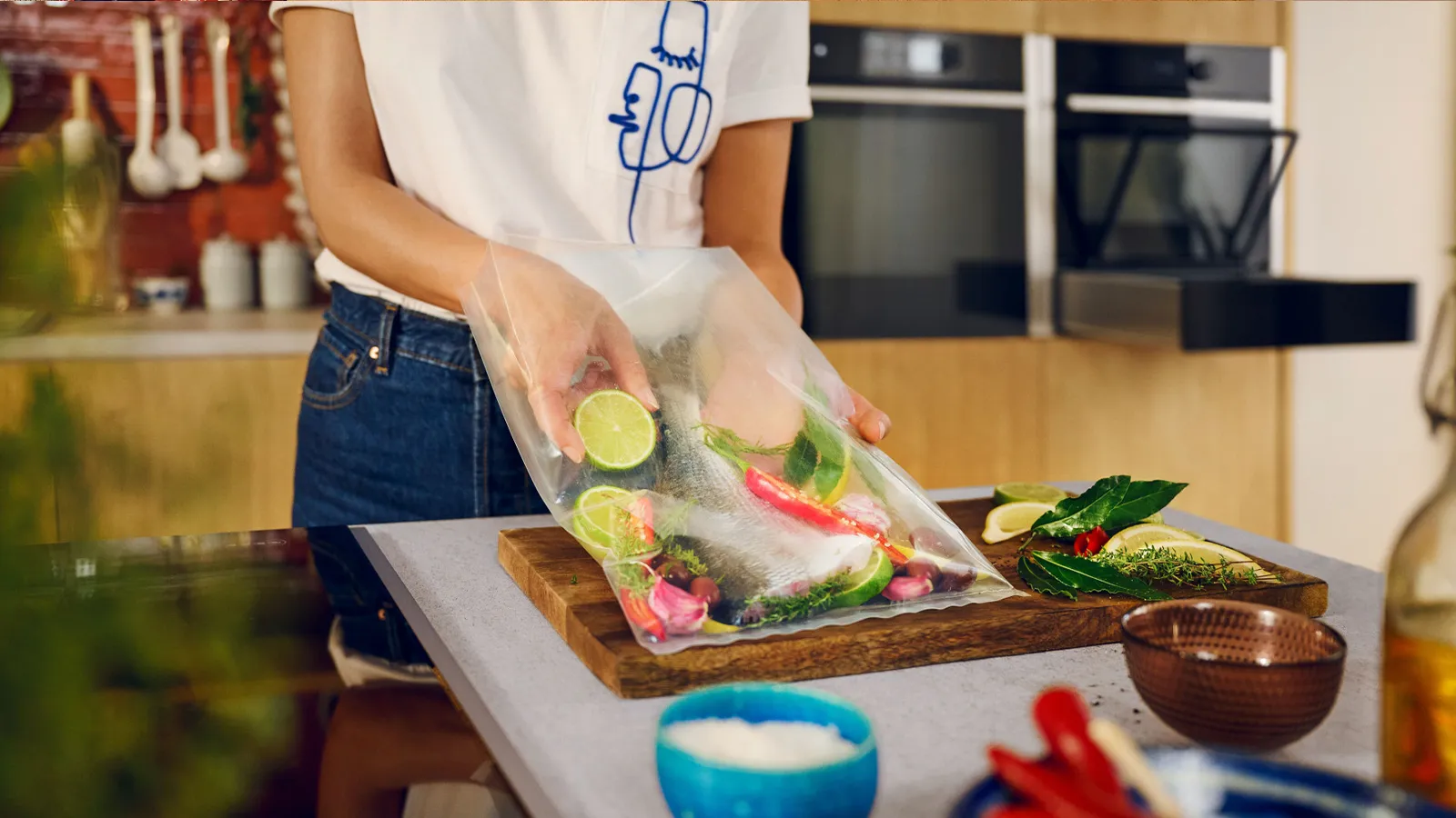 In a kitchen, a woman holds a bag of food, indicating she is about to cook or prepare a meal.