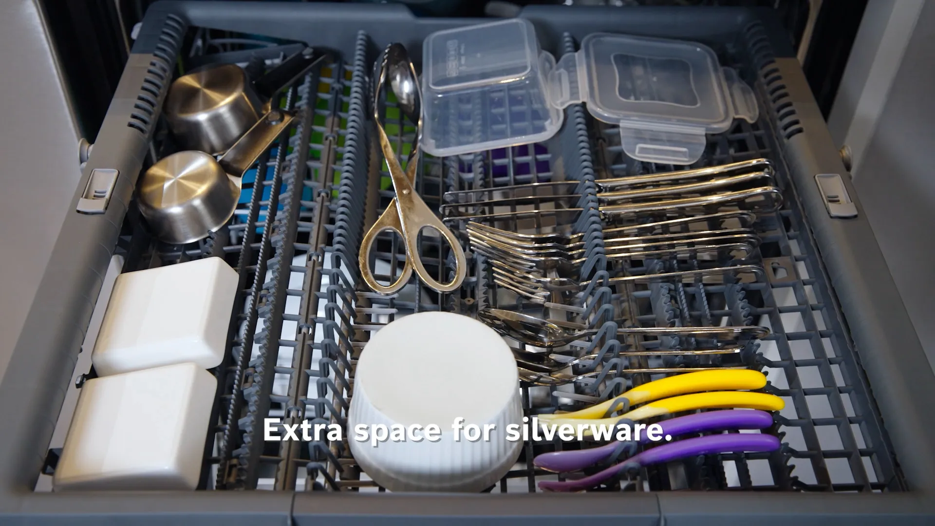 Bosch Dishwasher rack with multiple utensils, scissors, and containers for organized storage.