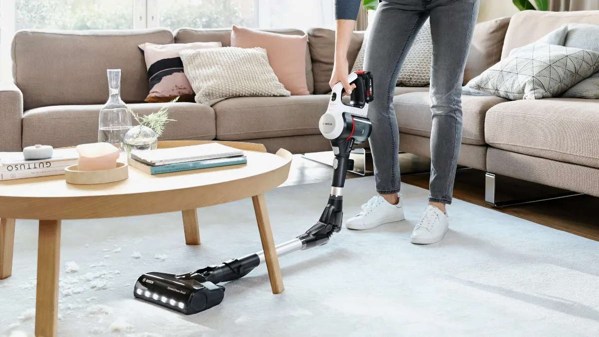 Person using Bosch Vacuum Cleaner flexibly under table