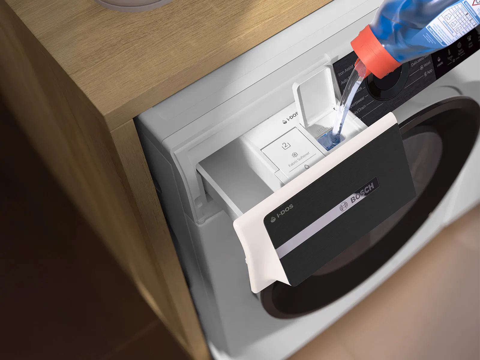 En person häller tvättmedel i tvättmedelsfacket på en Bosch-tvättmaskin och lyfter fram dess eleganta design och funktionalitet.