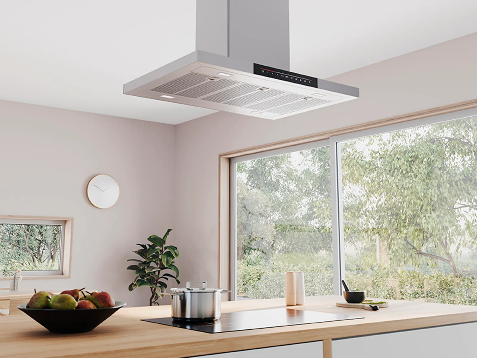 Modern kitchen featuring a stylish hood above a wooden island, with a pot and fruit bowl.