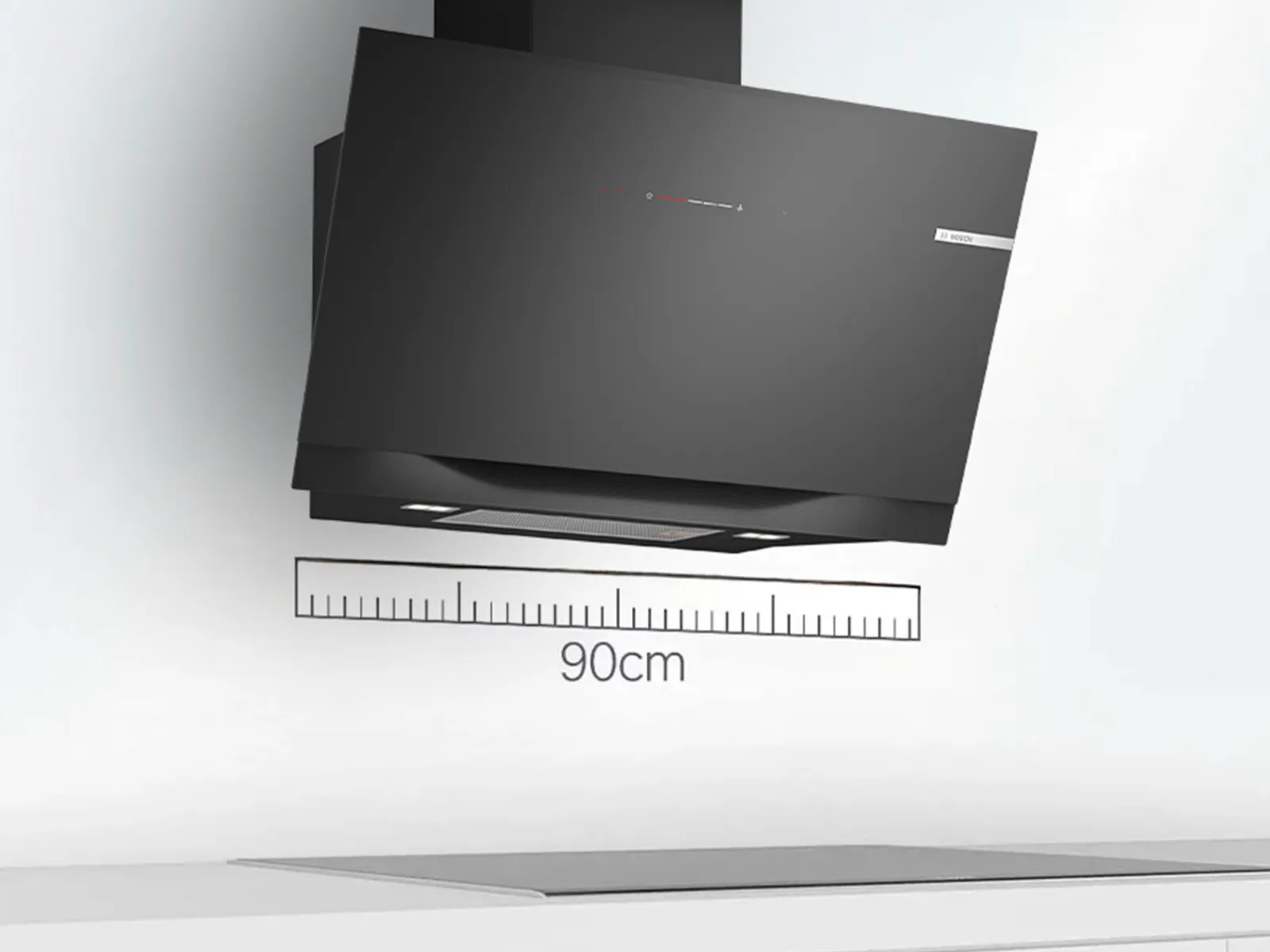 A black kitchen hood mounted above a cooktop, with a 90cm measuring scale displayed for reference.