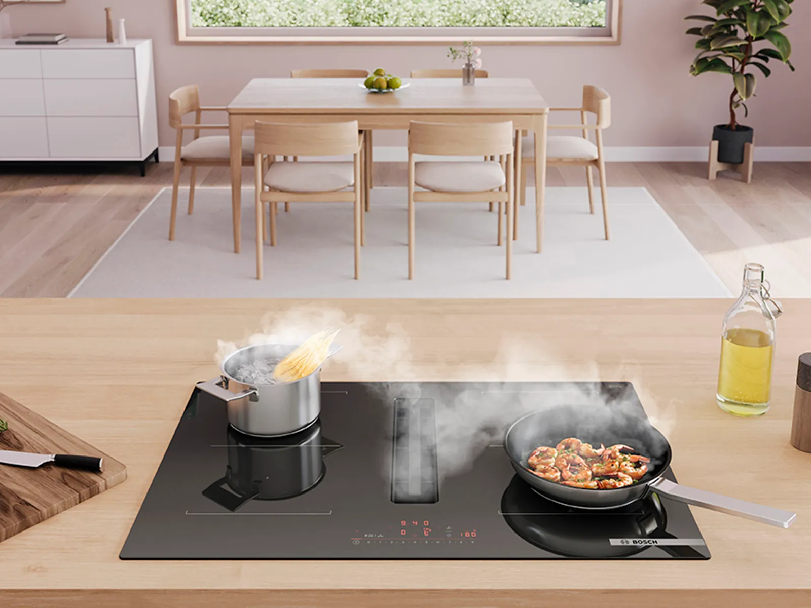 A modern kitchen, featuring boiling pasta and sizzling shrimp on an induction cooktop.