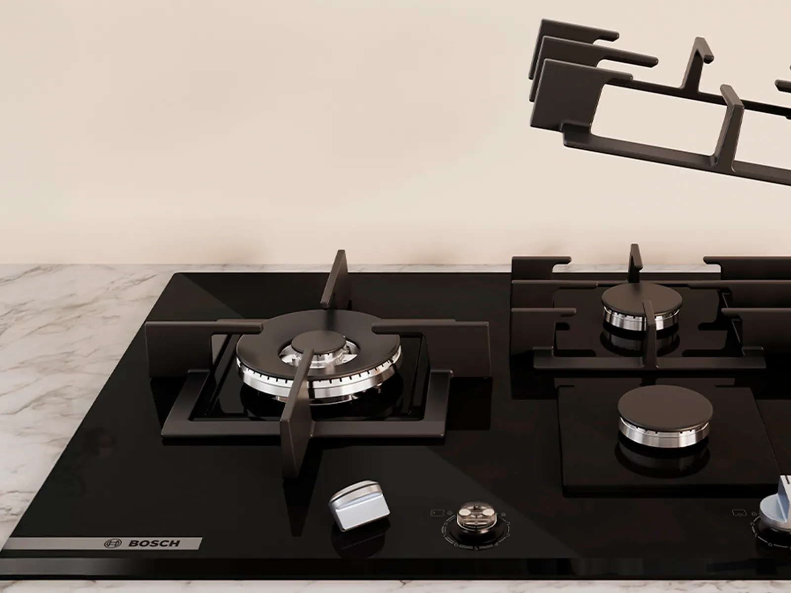  sleek black gas cooktop with five burners, featuring a removable griddle and control knobs.