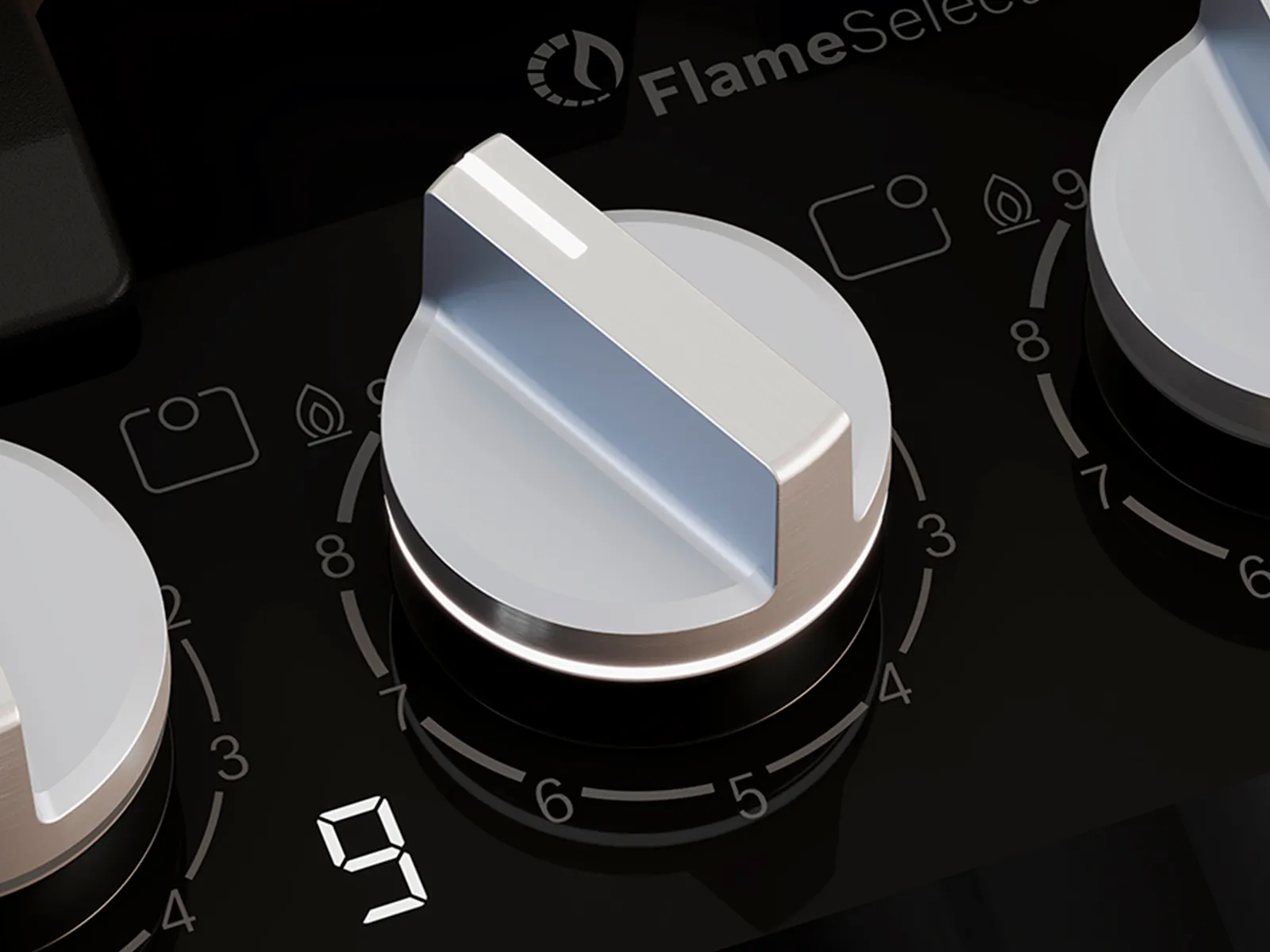 Close-up of a sleek stovetop control panel with three silver knobs and digital flame level indicator.