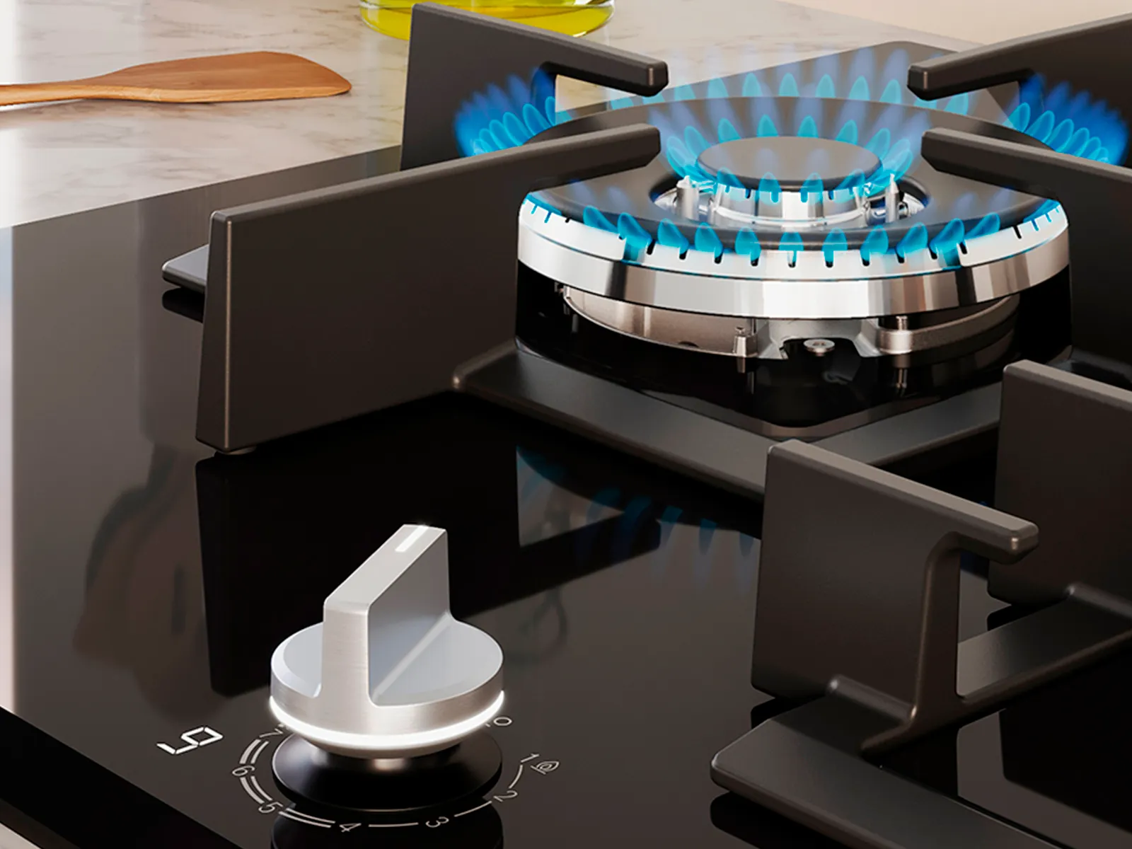 A modern gas stovetop with a lit burner producing blue flames, next to an olive oil bottle and wooden spoon.