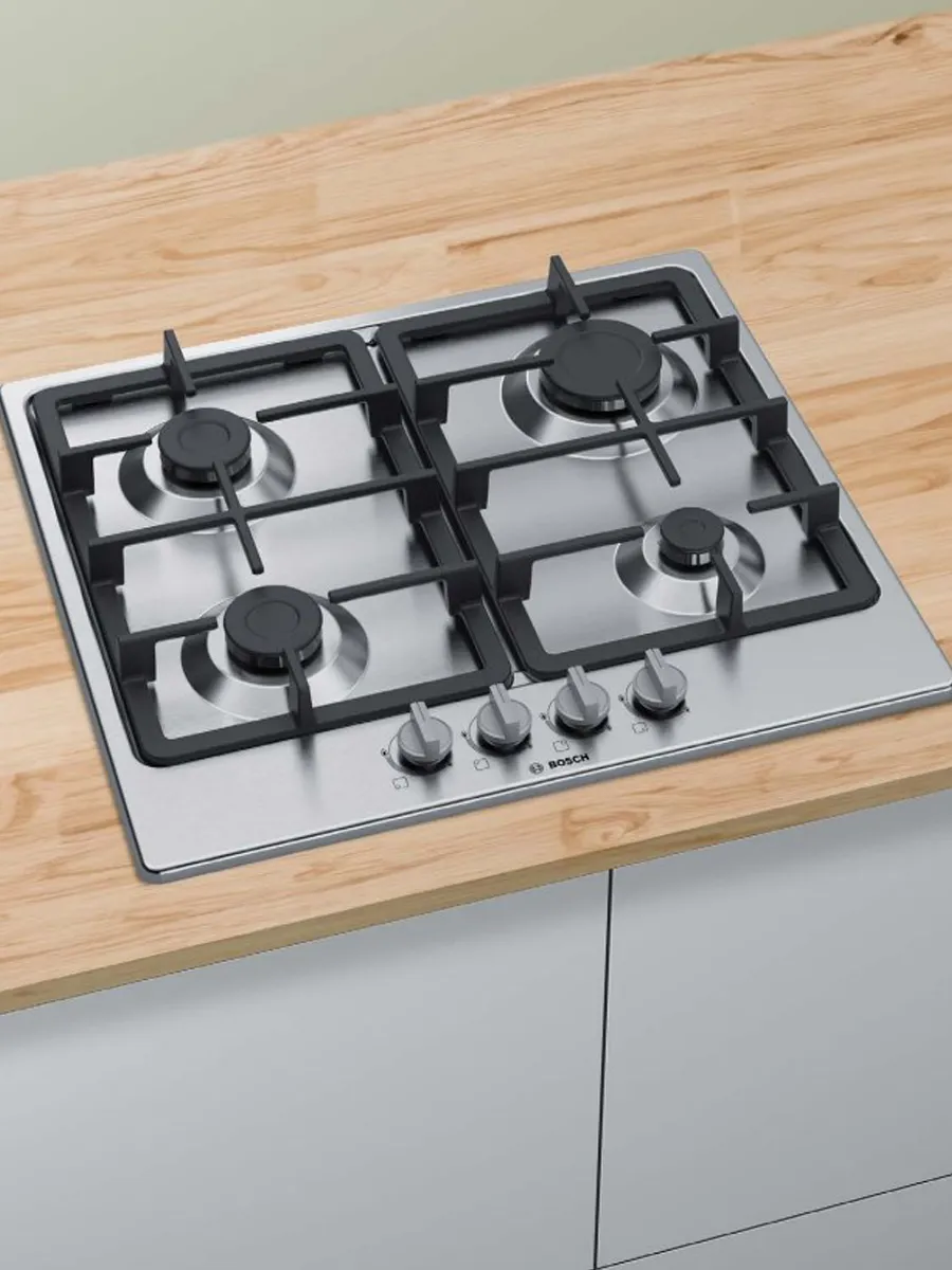 Gas hob on wooden countertop.