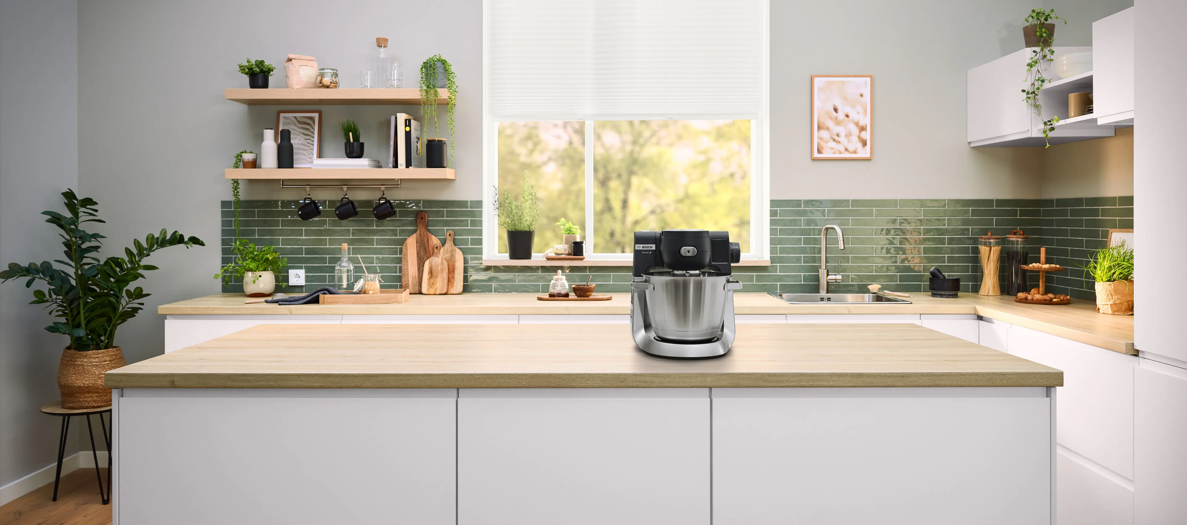 Series 6 kitchen machine on a kitchen countertop and a man who makes a magic hand movement.