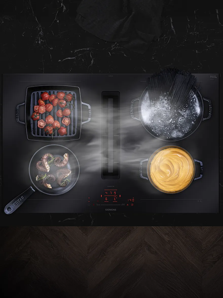 A top view of a flexZone hob featuring pots and pans with food