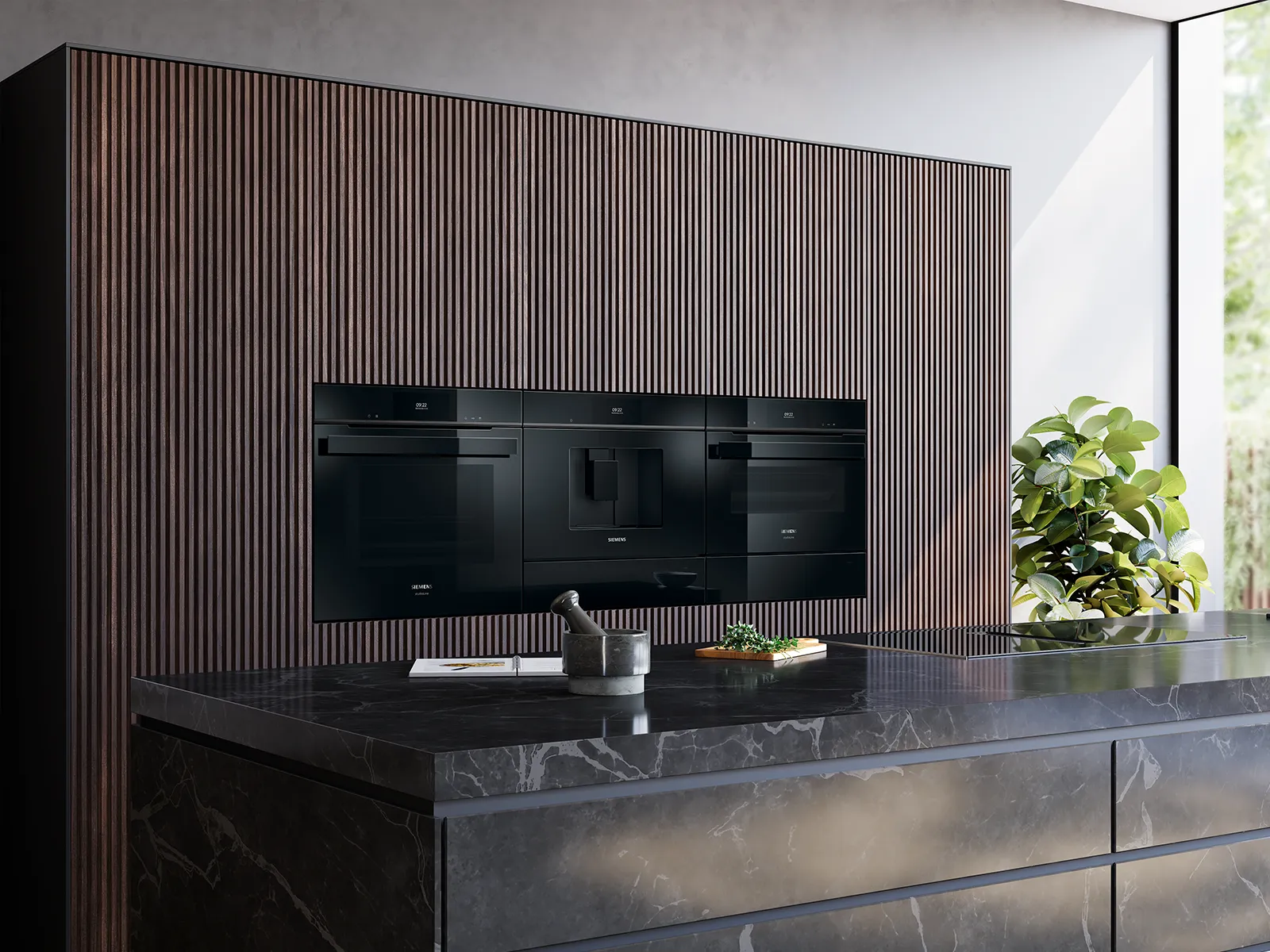Modern kitchen with built-in black oven and coffee maker, dark marble island, and large window.