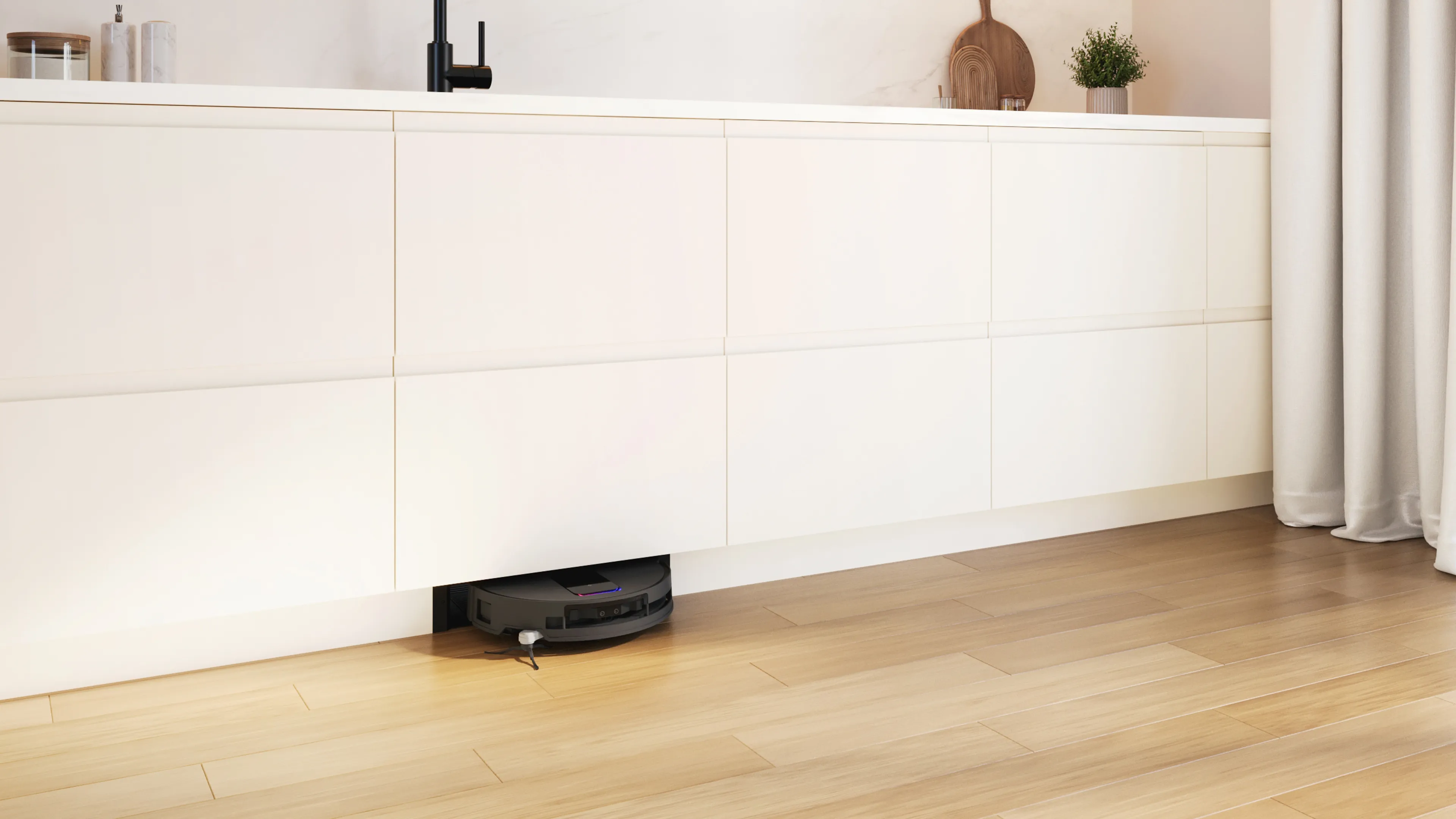Eine helle Einbauküche mit weißen Möbel mit dem neuen Einbau Saug- und Wischroboter und Bosch.