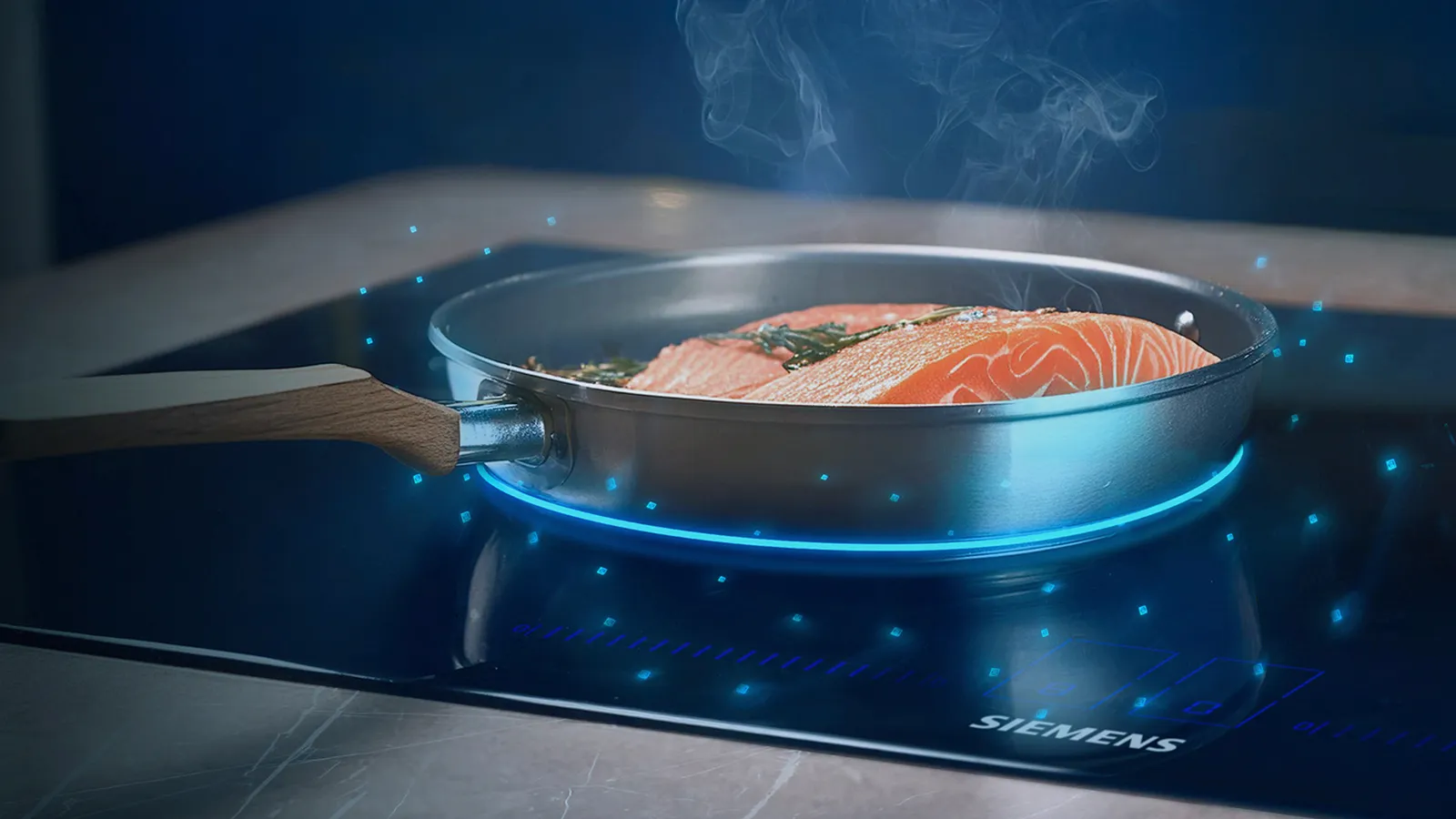 Salmon cooking in pan on induction hob with frying sensor