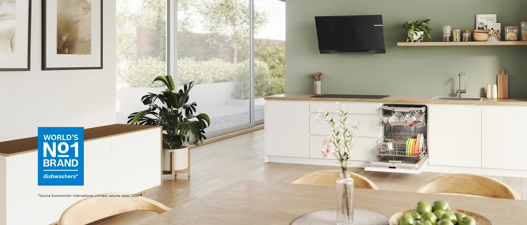 A modern kitchen featuring an open dishwasher loaded with clean dishes.