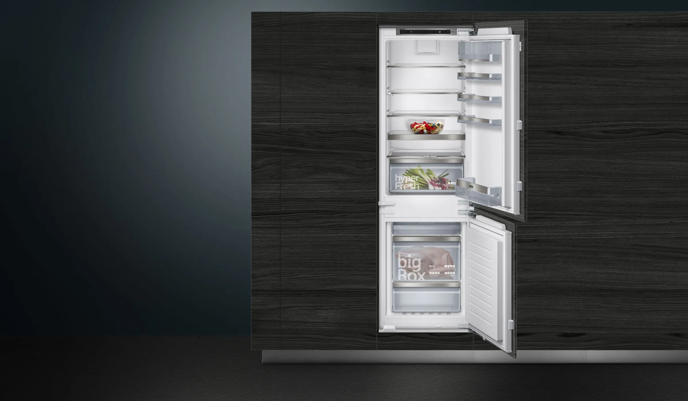 A large, dark grey Siemens refrigerator in a stylish, modern kitchen environment.