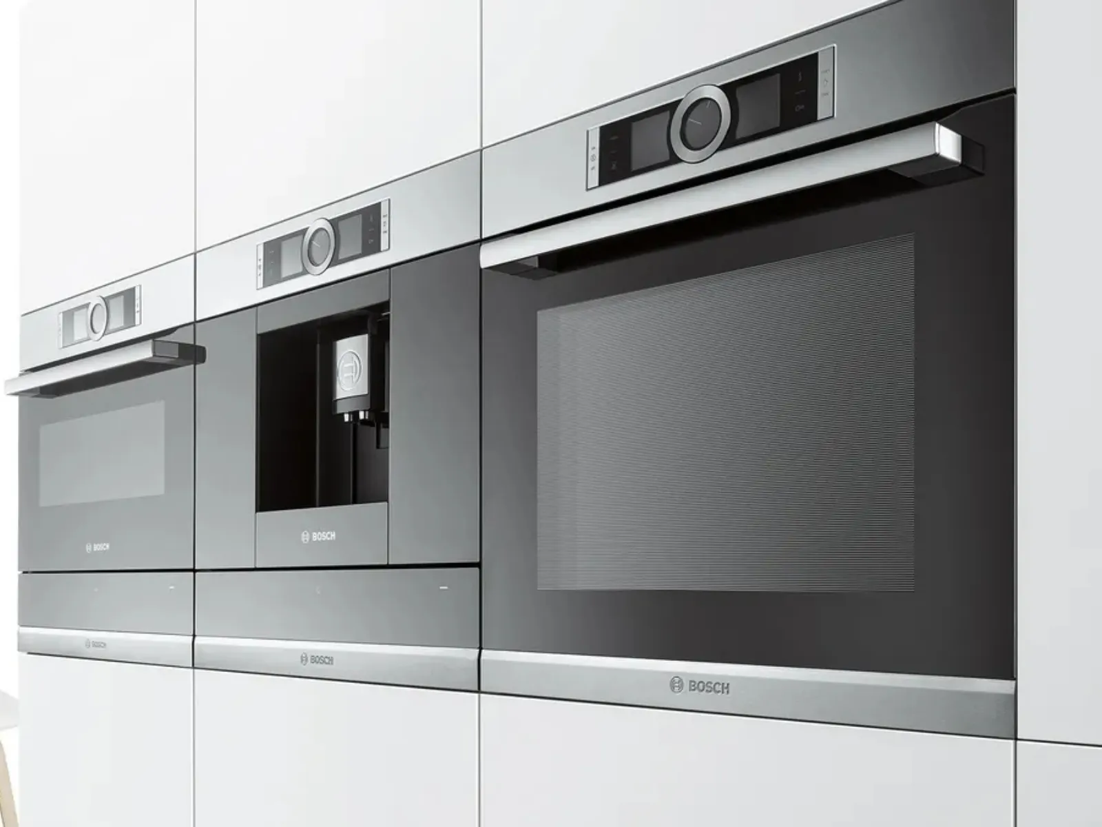 A modern kitchen with black cabinetry featuring built-in appliances and a plate of salmon with vegetables.