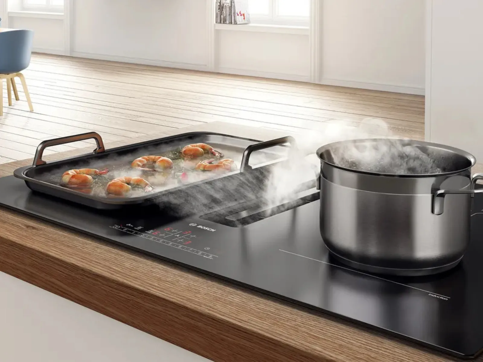 A kitchen countertop featuring a black grill with colorful vegetables.