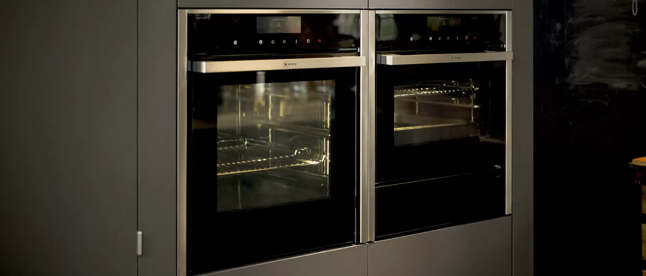  Two integrated ovens with Warming Drawers beside each other in high kitchen cupboards