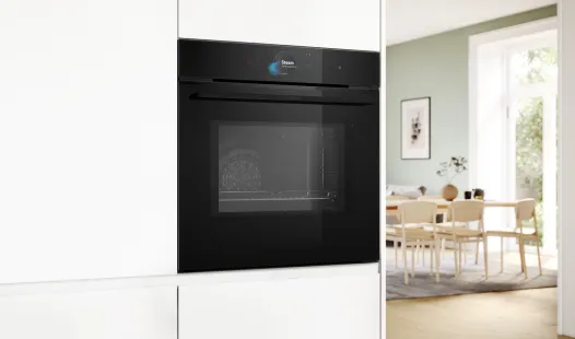 A black Bosch built-in oven integrated into white kitchen cabinetry in a modern home.